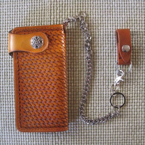 Cartera de motorista con herramientas a mano, lazo de cinturón y juego de cadenas.