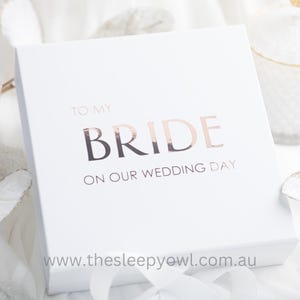 May include: White gift box with a rose gold foil inscription that reads "To My Bride On Our Wedding Day" and the website address "www.thesleepyowl.com.au".
