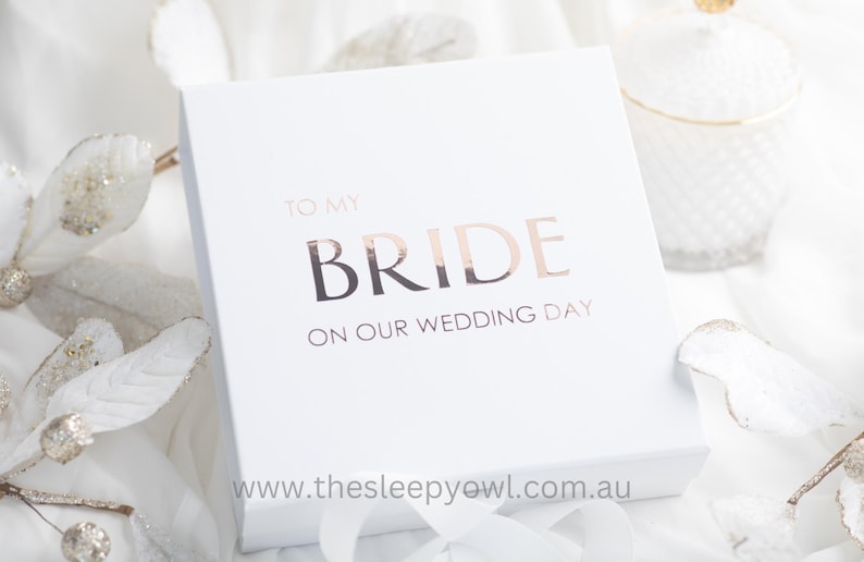 May include: White gift box with a rose gold foil inscription that reads "To My Bride On Our Wedding Day" and the website address "www.thesleepyowl.com.au".