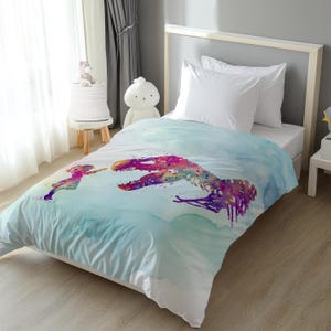 May include: A twin-size duvet cover featuring a watercolor design of a dinosaur skeleton and a child. The design incorporates shades of blue, purple, pink, and orange. The bedding is on a white bed frame.
