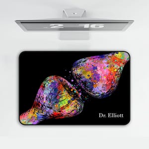 May include: Black rectangular mousepad featuring a colorful abstract watercolor design of two connected shapes. The shapes are filled with vibrant hues of red, blue, yellow, and green. The text "Dr. Elliott" is printed in white on the lower right.
