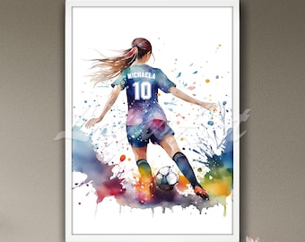 May include: Watercolor painting of a soccer player kicking a ball. The player is wearing a blue jersey with the name "Michaela" and the number "10" on the back. The background is a colorful watercolor splatter.