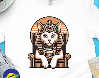 May include: A white t-shirt with a graphic of a cat wearing a golden crown and sitting on a throne. The cat has white fur and blue eyes. The background is a sunset orange color.