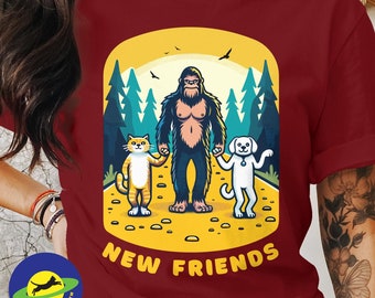 Big Foot Sasquatch becomes friends with a cat and a dog, funny t-shirt for lovers of cats, dogs and the outdoors.