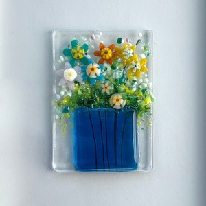 Glass picture of colorful flowers in a vase make an everlasting bouquet in a simple white wood frame