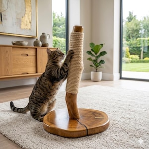May include: A wooden cat scratching post with a natural rope scratching surface. The post is attached to a round wooden base. A tabby cat is using the scratching post. The post is designed to provide a place for cats to scratch and exercise.