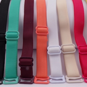 May include: A selection of colourful bra straps in shades of yellow, black, teal, burgundy, orange, white, beige, pink, and yellow. Each strap has adjustable plastic hardware for secure attachment.