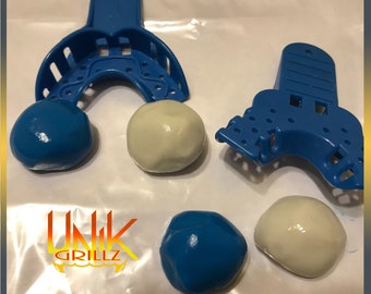 May include: Two blue and two white impression material balls next to two blue plastic dental impression trays. The trays are used to take impressions of teeth for dental work. The impression material is used to create a mold of the teeth.