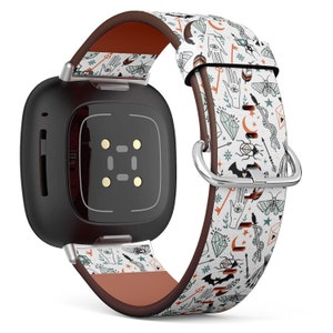 May include: A black smartwatch with a patterned band featuring a white background and various illustrations in orange, green, and black. The band has a brown leather backing and a silver buckle.