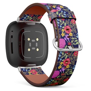 May include: A black smartwatch with a floral patterned leather band. The band has a dark blue background with pink, red, yellow, and green flowers.