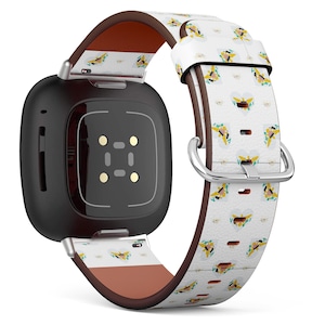 Könnte beinhalten: Eine schwarze Smartwatch mit einem weißen und gelben gemusterten Lederarmband. Das Armband zeigt ein sich wiederholendes Muster der Flagge der Jungferninseln.