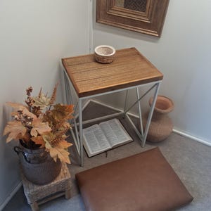 May include: A rustic wooden sign with the text "Welcome to our home" in white lettering. The sign features a distressed finish and a simple, inviting design, perfect for front door decor.