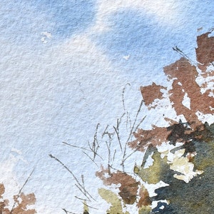 May include: Watercolor painting of a landscape with a blue sky and brown and green foliage. The artwork has a textured appearance, with visible brushstrokes and color blending. The painting evokes a sense of nature and tranquility.