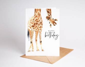 May include: A birthday card featuring a watercolor illustration of a giraffe peeking over the top of the card. The text "Happy birthday" is written in black cursive script.