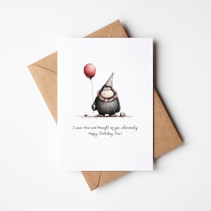 May include: A white greeting card with a watercolor illustration of a cartoon character holding a red balloon. The character wears a party hat and a floral necklace. The card is on a brown envelope, with the text "I saw this and thought of you, obviously. Happy Birthday Bro!"