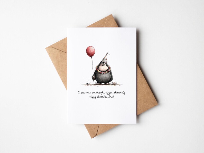 May include: A white greeting card with a watercolor illustration of a cartoon character holding a red balloon. The character wears a party hat and a floral necklace. The card is on a brown envelope, with the text "I saw this and thought of you, obviously. Happy Birthday Bro!"