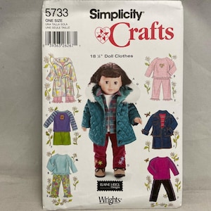 May include: A Simplicity Crafts sewing pattern envelope 5733 for 18 1/2 inch doll clothes. The front features a central image of a doll wearing a teal quilted jacket with a white faux fur hood, a plaid shirt, and red pants with floral embroidery.