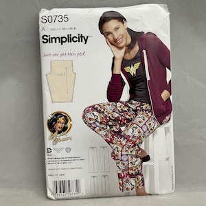 May include: Simplicity sewing pattern S0735 featuring Wonder Woman. The package shows a woman wearing a Wonder Woman t-shirt and pajama pants. The pattern is easy-to-sew and includes the text "Just one pattern piece!"