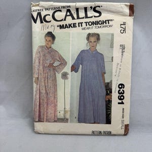 May include: A McCall's sewing pattern envelope for a robe, numbered 6391 in size small. The cover features two illustrations of the garment: one in a pink floral print with long sleeves and one in a solid blue with three-quarter length sleeves.