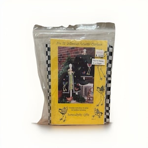 May include: A kit for making a jacket and matching accessories, packaged in a clear plastic bag. The kit includes a yellow booklet with the title "No. 27 Julianne's Eclectic Chickens" and illustrations of chickens. The kit is from Serendipity Gifts.