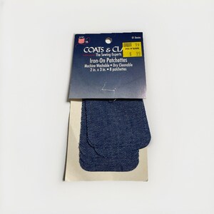 May include: A package of eight blue denim iron-on patchettes by Coats & Clark. The packaging features the text Iron-On Patchettes, Machine Washable, Dry Cleanable, and 2 in. x 3 in. The patches are rectangular with rounded corners and a textured finish.