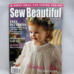 May include: A Sew Beautiful magazine issue 106 featuring a child wearing a white lace dress and a floral crown. The cover text includes 35 Great Ideas for Spring Sewing, Free Patterns, Smocked Skirt & Top, Surplice Wrap Baby Bubble, and Vintage Lace.