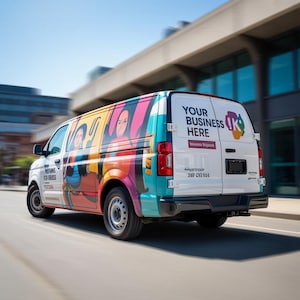 May include: A white commercial van with colorful graphics and the text "YOUR BUSINESS HERE." The van has a vibrant design with images of people and abstract shapes. The vehicle is driving on a road.