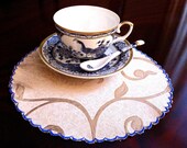 round embroidered napkins, tea napkins, circle doilies with blue edge.