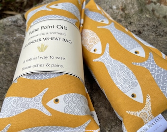 Fish print lavender scented wheat bag in sunshine yellow. Heat pad for aches and aches.