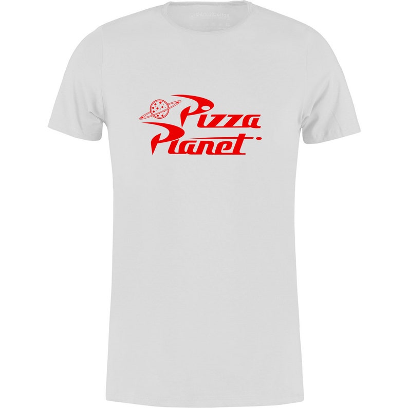May include: White t-shirt with a red "Pizza Planet" logo. The logo features a stylized planet with a pizza slice in the center.