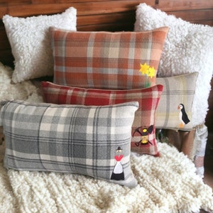 Embroidered cushions with Welsh motifs, Welsh lady, Miners Lamp, Daffodils, Puffin