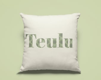 May include: White pillow with the word "Teulu" printed in green on the front. The word is in a patterned font.