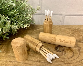 May include: Two bamboo cases with lids containing reusable cotton swabs with white silicone tips. The cases are engraved with the words "Willowood" and "Naturally".