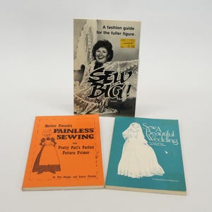 May include: Three sewing books with colorful covers. The first book is titled "Sew Big!" and features a woman in a dress. The second book is titled "Painless Sewing with Pretty Pati's Perfect Pattern Primer" and features a woman in a dress. The third book is titled "Sew a Beautiful Wedding" and features a bride in a white dress.