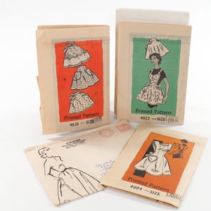 May include: Vintage printed sewing patterns featuring skirt and dress designs. The patterns are in tan envelopes with illustrations and text, including "Printed Pattern" and size information. The image shows multiple patterns, with designs in red and green.