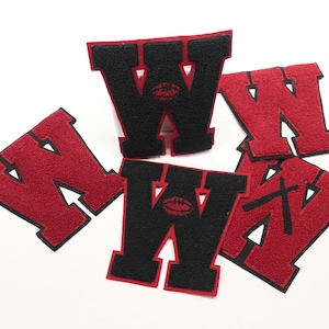 May include: Five felt patches in the shape of the letter W. Two are black with a red football design and three are red with a black football design.