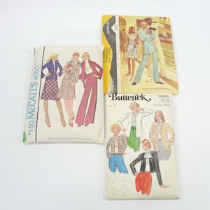 May include: Three vintage sewing patterns for women's clothing. The patterns are from McCall's and Butterick. The McCall's patterns are for a skirt and pants, and the Butterick pattern is for a jacket. The patterns are all in color and feature illustrations of the garments.