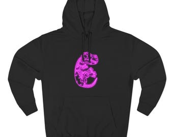 May include: Black hoodie with a neon pink dinosaur design on the front. The dinosaur is stylized with a skeletal outline. The hoodie has a drawstring hood and a front pocket. A casual, comfortable garment.
