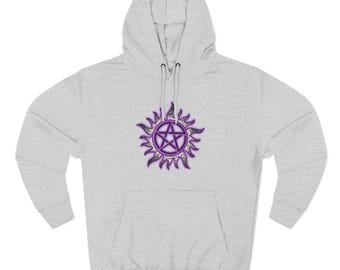 May include: A light gray hooded sweatshirt with a front pocket and a drawstring hood. The sweatshirt features a purple and black sunburst design with a pentagram in the center. The design is centered on the chest.