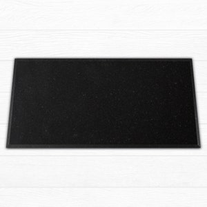 May include: A black rectangular doormat with a textured surface.