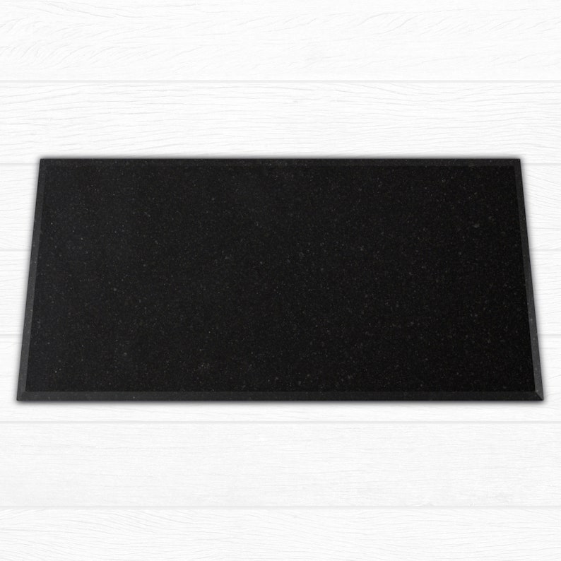 May include: A black rectangular doormat with a textured surface.