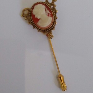 Vintage Cameo Stick Pin, Brooch.  Ornate Victorian Style in Gold Tones with Creamy White Silhouette on Peach Background