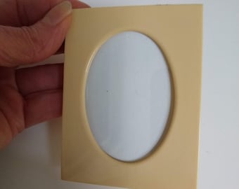 Vintage Small Celluloid Standing Photo Frame, Oval Opening for 2"x3" image, Small Pale Yellow Plastic Picture Frame