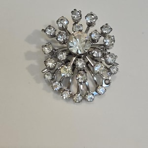 Vintage Starburst Clear Rhinestone Brooch set in Silver Toned Metal