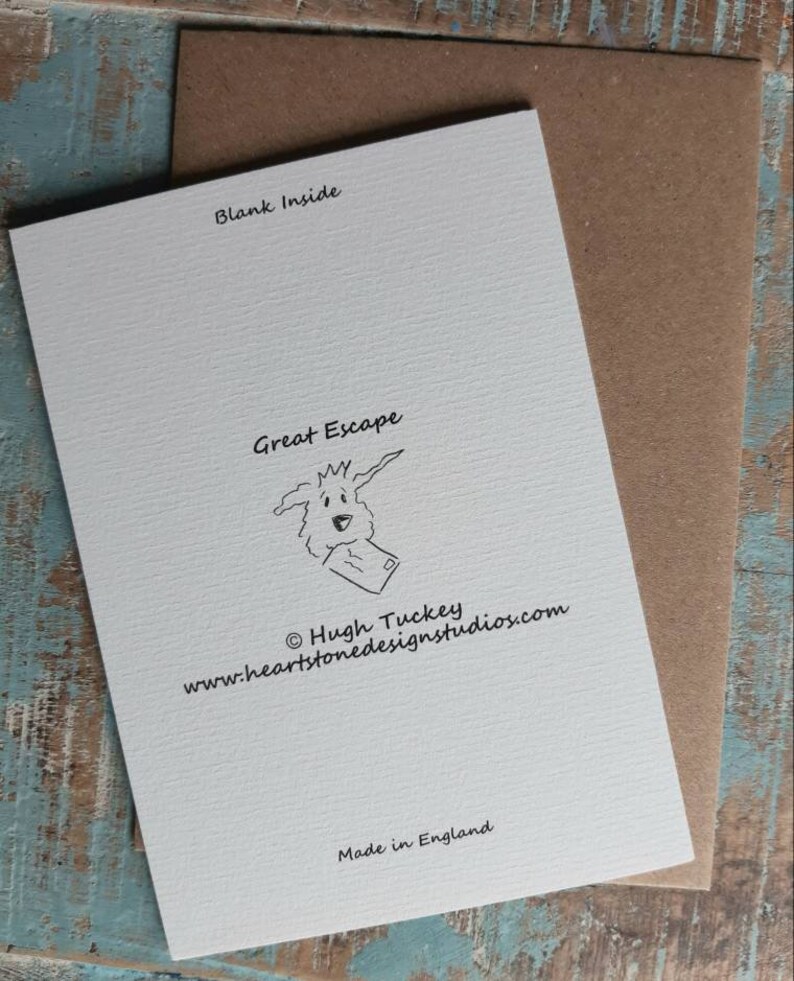 May include: A white card with black text that reads "Blank Inside", "Great Escape", "&copy; Hugh Tuckey", "www.heartstonedesignstudios.com", and "Made in England". The card features a cartoon illustration of a dog with a letter in its mouth.