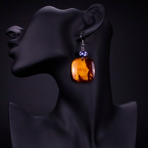 Handmade earrings. Urushi (Japanese lacquer) and silver leaf on wood with handmade beads.