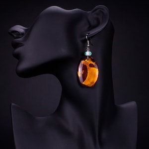 Handmade earrings. Urushi (Japanese lacquer) and silver leaf on wood with handmade beads.