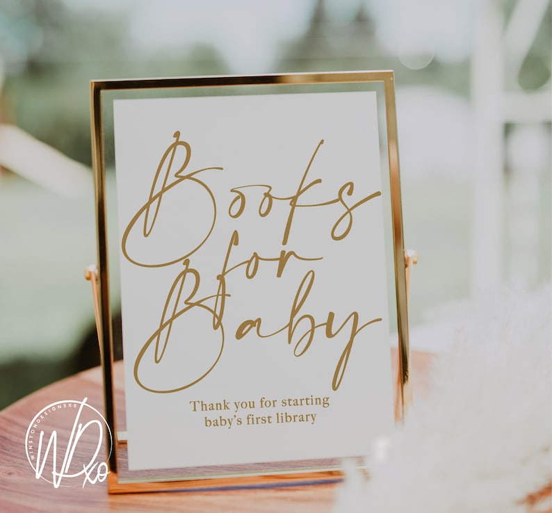 Puede incluir: Un cartel enmarcado en dorado con el texto "Books for Baby" en escritura dorada. El cartel tambi&eacute;n incluye el texto "Thank you for starting baby's first library".