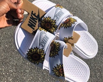 white sunflower nike slides