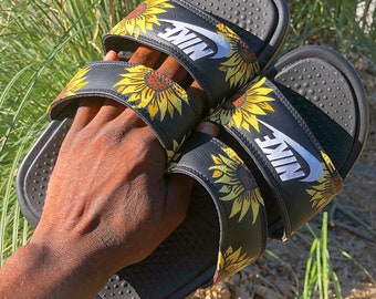 white sunflower nike slides